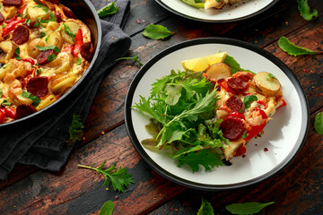 Chorizo Frittata with salad on black and white plate. healthy morning breakfast food