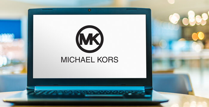 Laptop computer displaying logo of Michael Kors