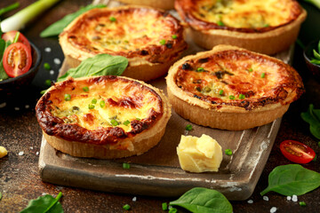 Cheddar cheese and spring onion omelette tarts served on wooden board with side salad. Healthy breakfast food