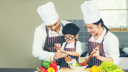 Cooking Family. Chef parent and kid boy make fresh vegetables salad for healthy eat.  