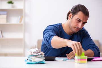 Young man in budget planning concept