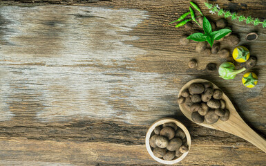 Thai Puffball wild mushrooms in wood spoon on wooden table background