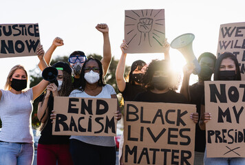 People from different culture and races protest on the street for equal rights - Demonstrators wearing face masks during black lives matter fight campaign - Focus on black woman face - obrazy, fototapety, plakaty