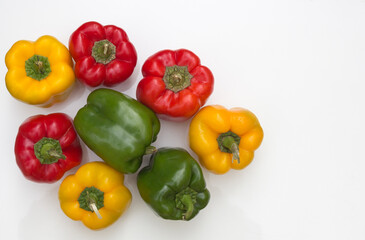 A Cluster  of Colorful Raw Bell Peppers or Capsicum on a white background in Food photography.