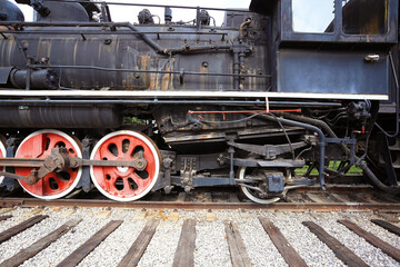 Old black steam train locomotive of partial closeup