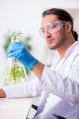 Young male chemist working in the lab