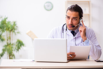 Young doctor listening to patient during telemedicine session