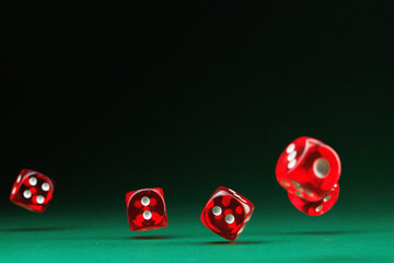 Red casino dices on a green background. Selective focus