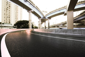 Empty road floor with city viaduct bridge of neon lights night