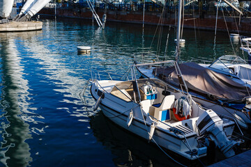 Yacht in port near the pier. Speed boat mooring. Boat Parking Boating Yachting Equipment.