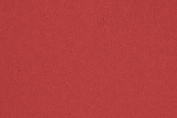 The surface of dark red cardboard. Paper texture with cellulose fibers. Saturated color. Background or wallpaper. Top view from above. Macro
