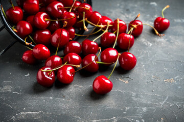 Ripe and juicy cherries on the dark rustic background. Selective focus. Shallow depth of field.