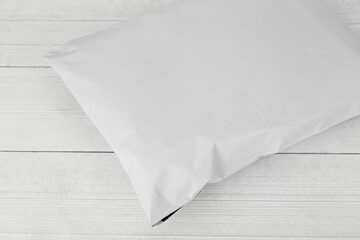 Blank white plastic bag packaging mockup on wooden background, Online shopping packaging, Packaging template.
