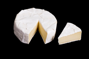 pieces of soft cheese Camembert on dark blackbackground. Delicious pieces of white mold cheeses with soft textures Camembert close up, macro