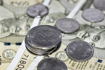 Pile of Indian 500 rupees Currency notes and coins. Selective focus applied.