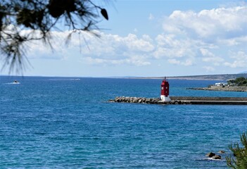 Red lighthouse and the sea horizon