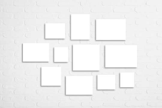 Blank canvas set isolated on white bricks wall	, interior decor mock up
