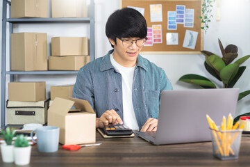 Asian man working with box to packaging for online business concept.