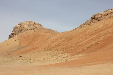 Hot and arid desert sand dunes terrain in Sharjah emirate in the United Arab Emirates. The oil-rich UAE receives less than 4 inches of rainfall a year and relies on water from desalination plants.