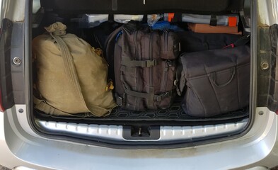 Backpacks and bags in the trunk of a car