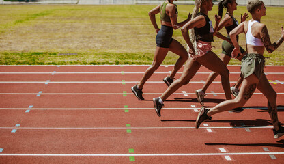 Female athletes running race on the track