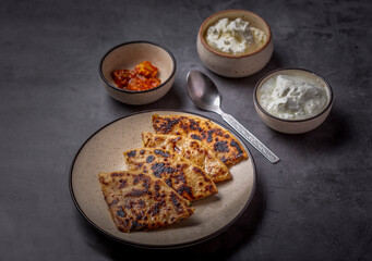 Aaloo parantha or stuffed potato flatbread with curd, pickle and homemade white butter