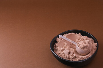 Whey chocolate protein scoop. Sports nutrition. Sports nutrition for building muscles, vitamins for making cocktails. Food for energy. Concept of food additives and dietary supplements. Copy space