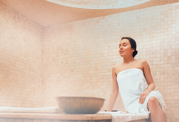 Attractive woman relaxing at hammam. Body recovery at hamam, traditional turkish bath - obrazy, fototapety, plakaty