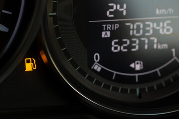 Empty fuel warning light in car dashboard. Fuel pump icon. gasoline gauge dash board in car with digital warning sign of run out of fuel turn on.  Low level of fuel show on speedometer dashboard.