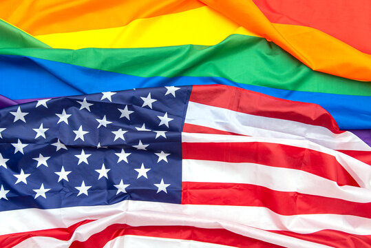 Fabric USA and gay pride rainbow flags as background, concept picture