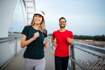 Obraz premium Beautiful couple running in nature living healthy