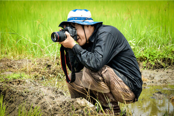 A farmer taking photos in the field