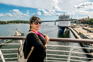  A woman stands on the deck of a ferry sailing to the Stadsgarden Ferry Terminal in Stockholm.