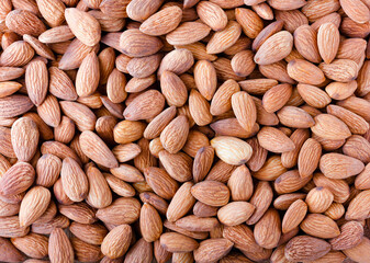 Almonds, a close-up photo. The background and texture of a walnut. Image.