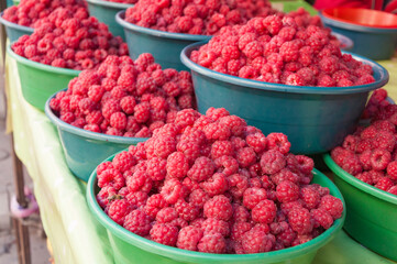 Fresh and juicy raspberries in the baskets, selling at the Osh Bazaar in Bishkek, Kyrgyzstan