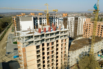 Construction and construction of high-rise buildings, the construction industry with working equipment and workers. View from above, from above. Background and texture