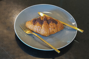 Chocolate croissant on a plate ready to eat