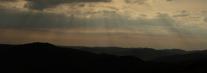 Beautiful sunset colors over the mountains of Carpathian, Ukraine, Europe. Sun setting after hot summer day. Photo in orange and blue natural tones.