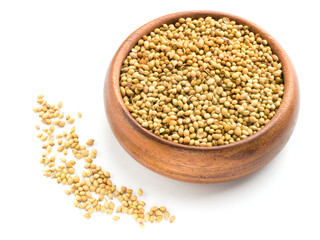 Spice coriander (Coriandrum sativum) seeds in wooden bowl isolated on white background. Diet and weight loss concept