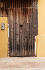 Old wooden door with a metal mailbox