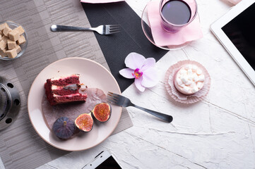 Fototapeta na wymiar life style set at meeting in cafe.Thai blue, Butterfly pea tea served with fresh figs and panna cotta cake and fruit piece of cake on serving napkins. flat lay