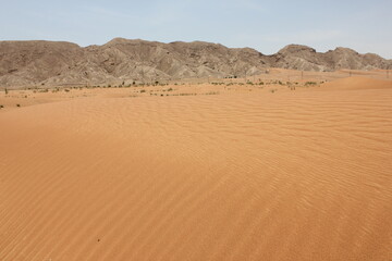 Hot and arid desert sand dunes terrain in Sharjah emirate in the United Arab Emirates. The oil-rich...