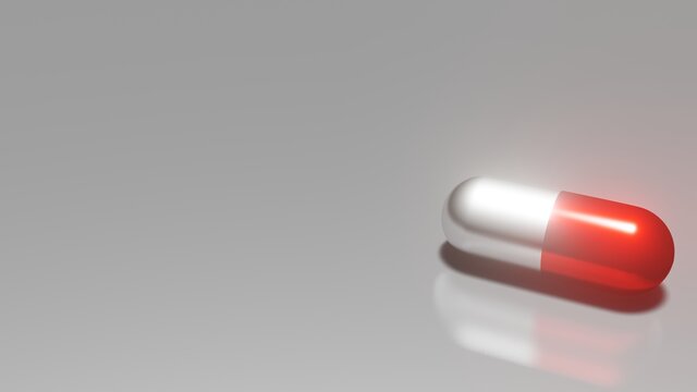 The image was created with a three-dimensional program the medicine capsules with red and white color place on a silver background