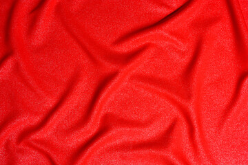 Texture of red luxury expensive fabric. Mockup of designer for making flag on wavy colorful background.