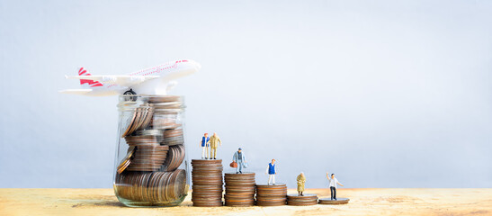 Miniature people standing on stack of coins. Inequality and social class. Income and economic...