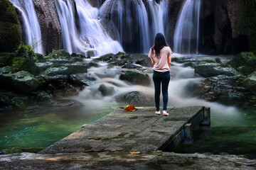 young woman in a waterfall