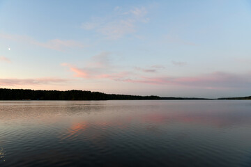 reflection of pink clouds in a river at sunrise