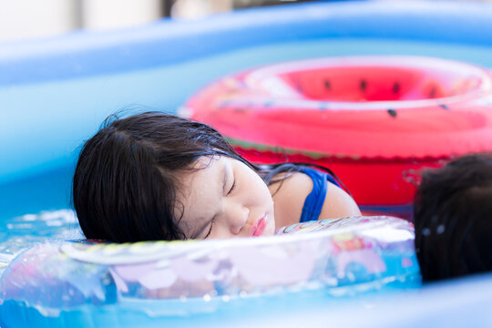 Children Sleep In The Pool. Dangerous If Letting Children Swim Without Adult Supervision Closely. Safety In Swimming In Children. Asian Children Aged 6 Years.