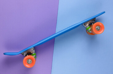 Plastic mini cruiser board on colored background. Pastel color trend. Summer fun. Youth...