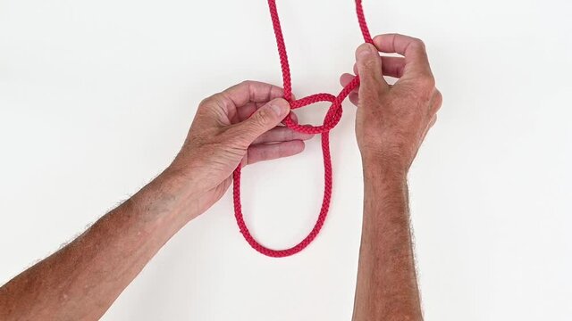 Demonstration of tying a loop in a rope the secure way with a bowline knot the fast fool proof way